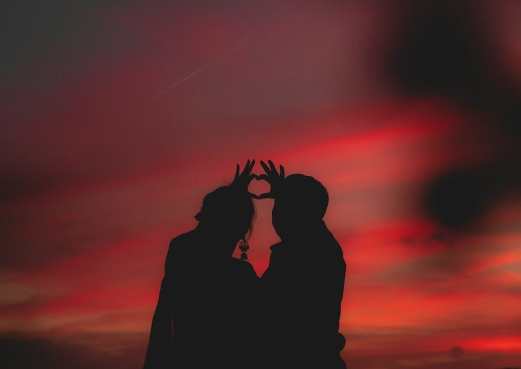 Romantic couple holding hands at sunset