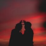 Romantic couple holding hands at sunset